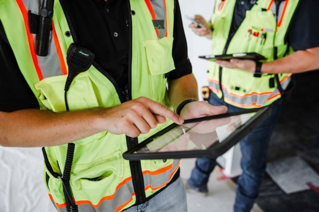 construction workers using tablets on jobsite.
